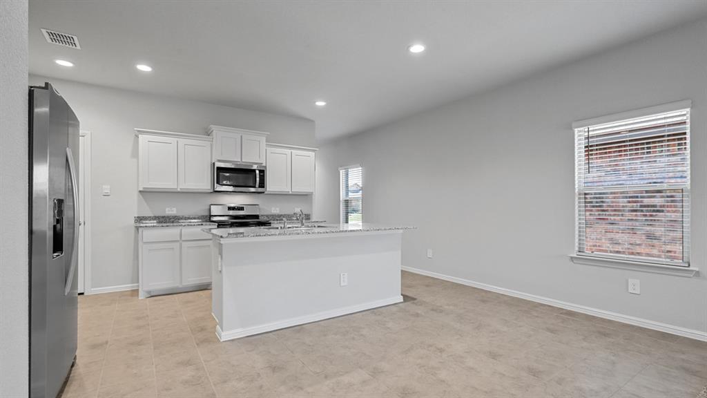120 Mojave Road Boyd, TX 76023 - Photo 8 of 40 a kitchen with stainless steel appliances a sink a stove a refrigerator cabinets and a window