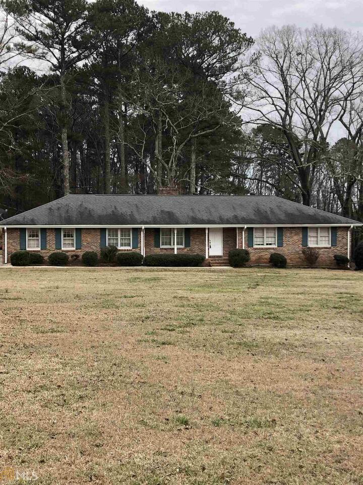 a front view of house with a garden