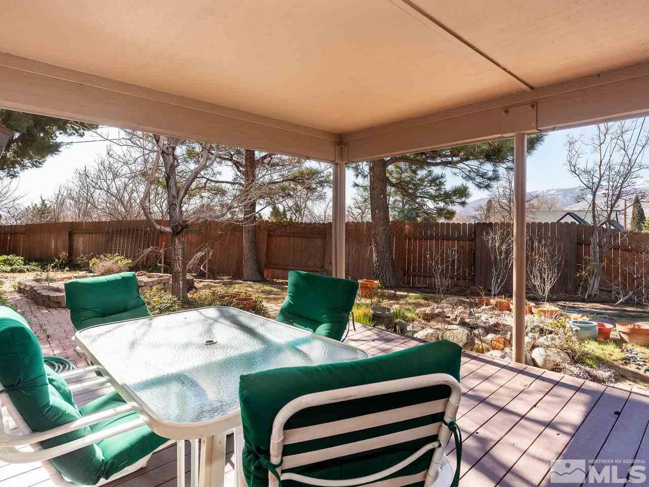 2490 Sutter Circle Reno, NV 89503 - Photo 13 of 16 a view of a patio with a dining table and chairs with a fire pit