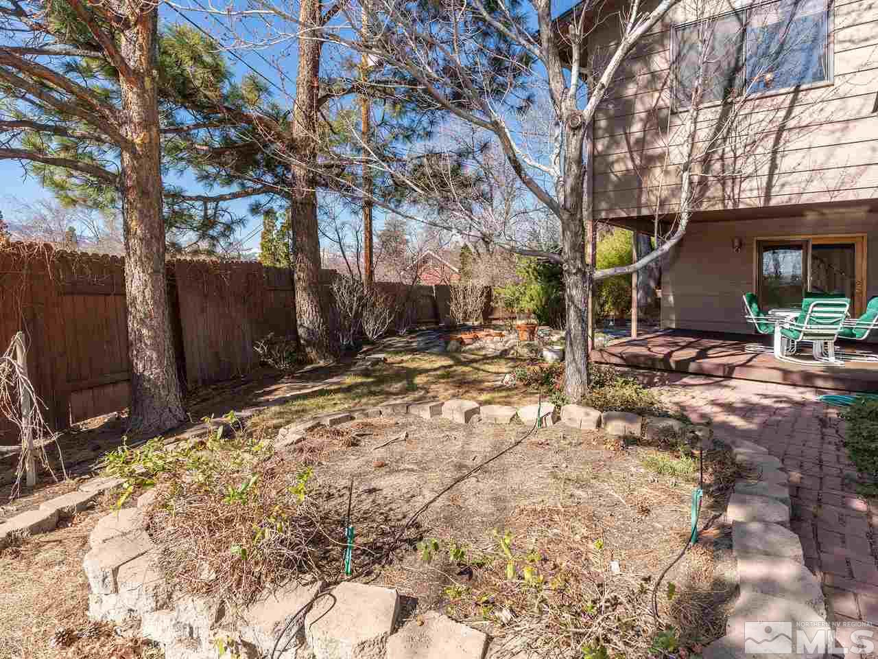 2490 Sutter Circle Reno, NV 89503 - Photo 16 of 16 a backyard of a house with table and chairs under an umbrella
