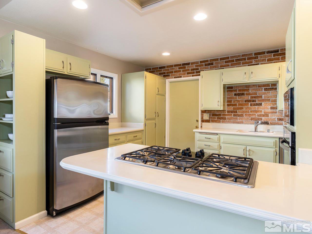 2490 Sutter Circle Reno, NV 89503 - Photo 4 of 16 a kitchen with a stove and a refrigerator