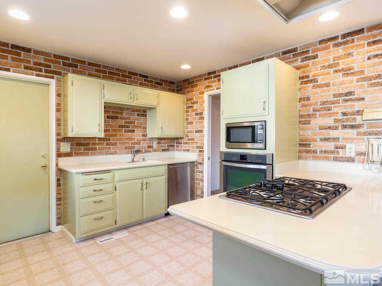 2490 Sutter Circle Reno, NV 89503 - Photo 5 of 16 a kitchen with a stove a sink and a refrigerator