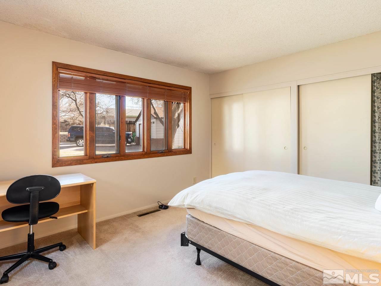 2490 Sutter Circle Reno, NV 89503 - Photo 7 of 16 a bedroom with a bed and a window