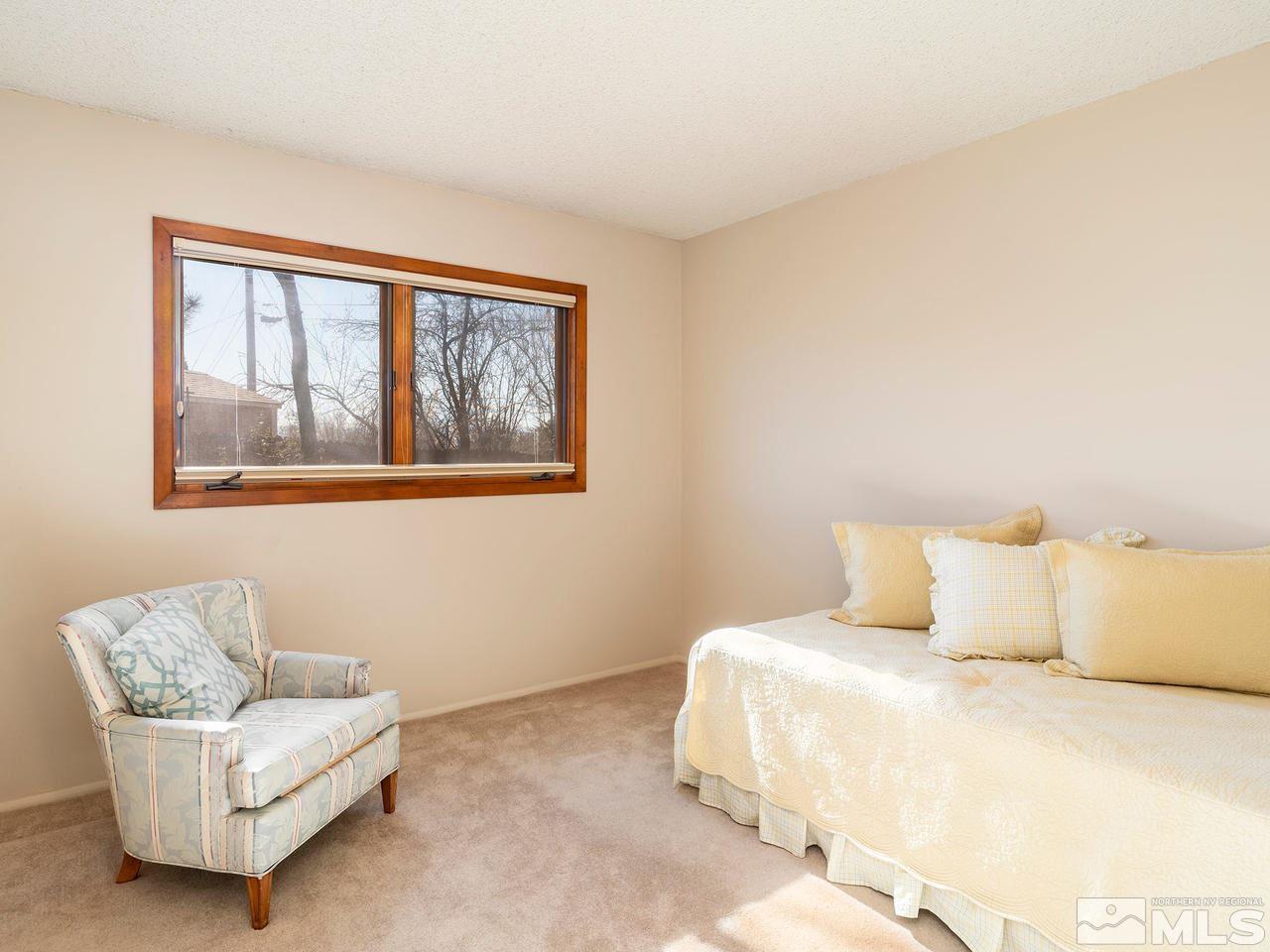 2490 Sutter Circle Reno, NV 89503 - Photo 8 of 16 a bedroom with a bed and a couch
