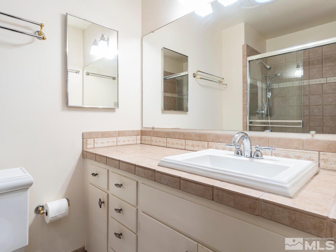 2490 Sutter Circle Reno, NV 89503 - Photo 10 of 16 a bathroom with a granite countertop sink mirror and double