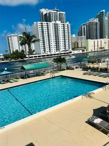 a front view of a building and lake