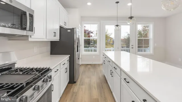 a kitchen with granite countertop a stove and a refrigerator