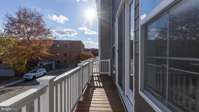 a view of a balcony with wooden fence and floor