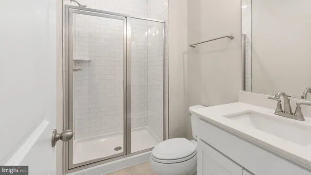 a bathroom with a shower a toilet and sink