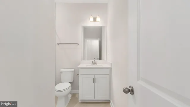 a bathroom with a sink toilet and mirror