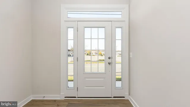 a view of an entryway with wooden floor