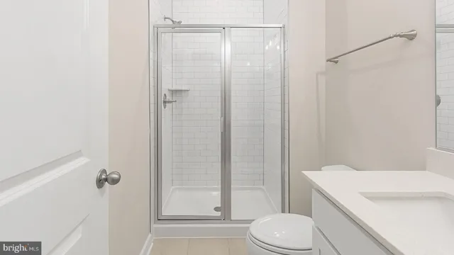 a white toilet sitting next to a bathroom sink