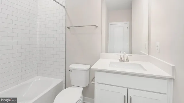 a bathroom with a sink toilet vanity and shower