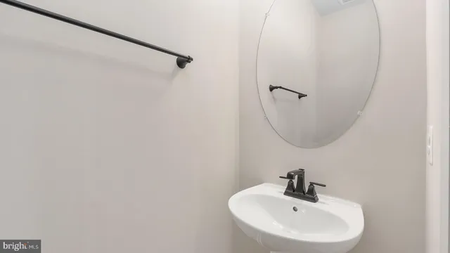 a bathroom with a sink a mirror and vanity