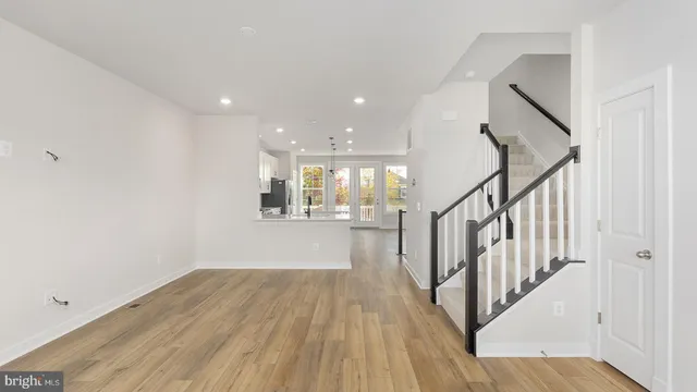 a view of a hallway with wooden floor and staircase