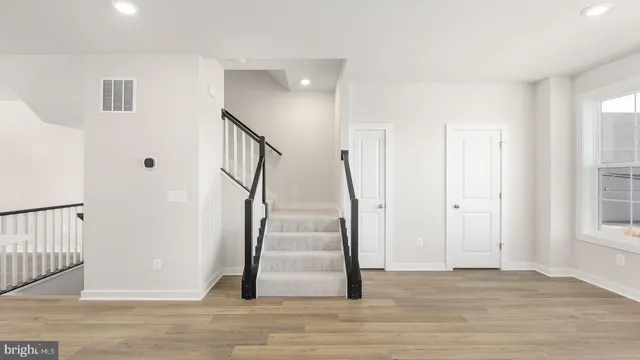 a view of entryway with wooden floor and stairs