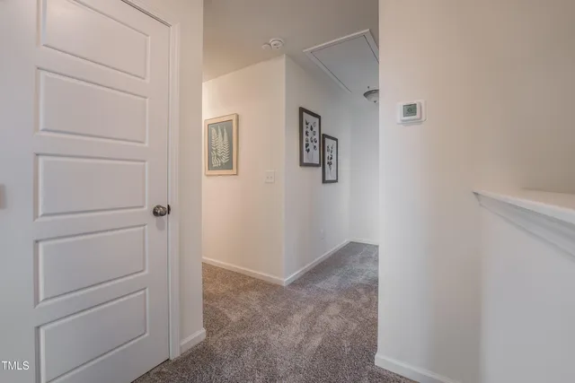 a large bedroom with a bed and a large mirror