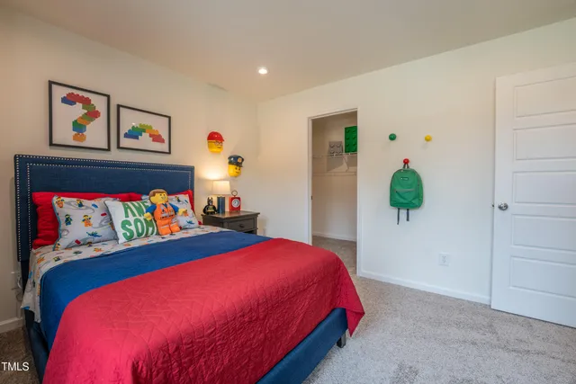 a bedroom with bed and a couch