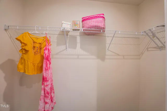 a bedroom with a bed next to a large window