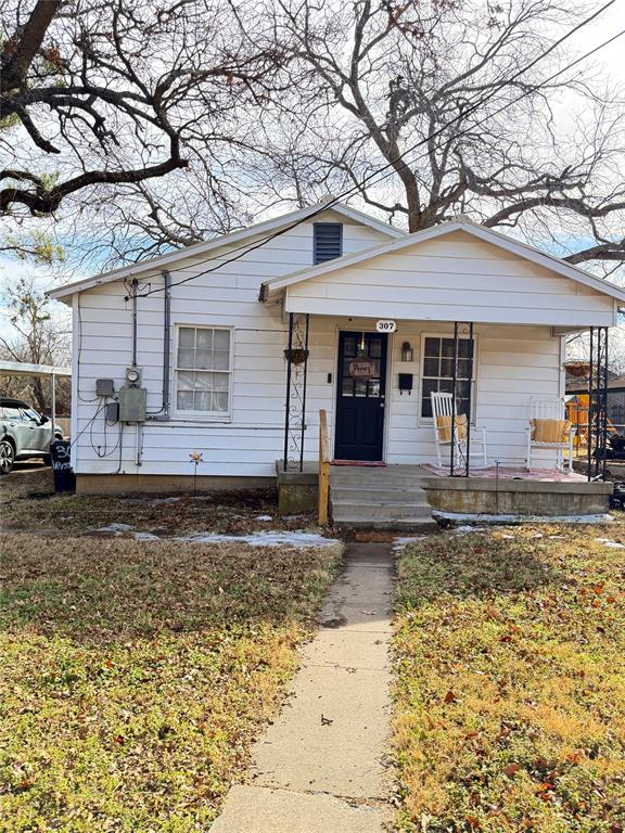 307 West Russell Street Weatherford, TX 76086 - Photo 1 of 9 a front view of a house with garden