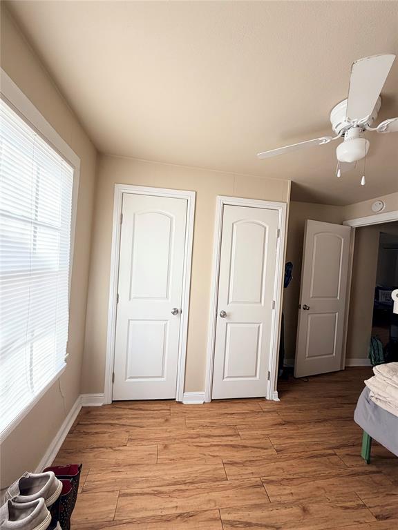 307 West Russell Street Weatherford, TX 76086 - Photo 6 of 9 a view of empty room with wooden floor and fan