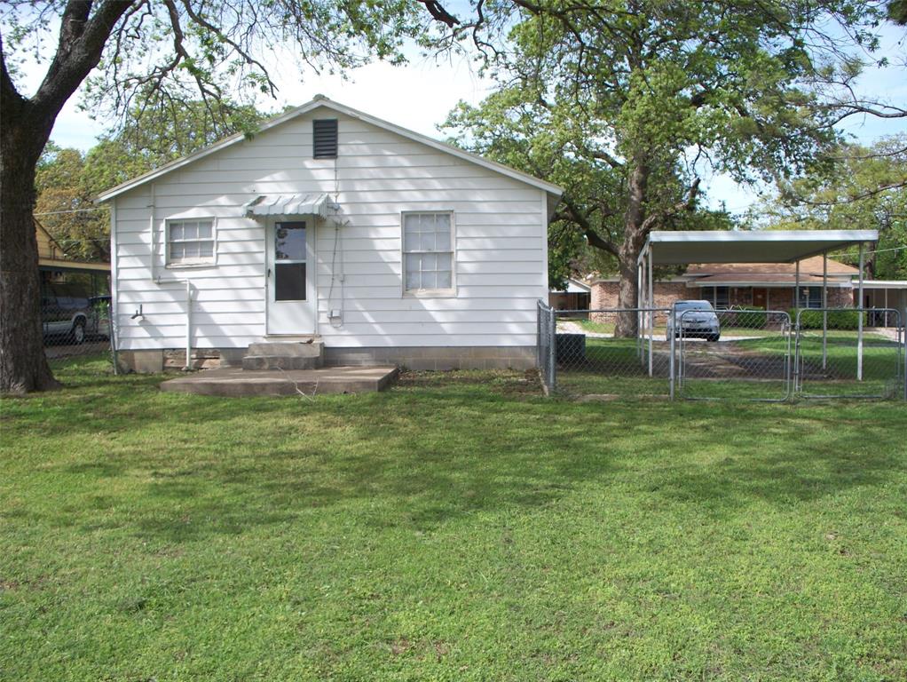307 West Russell Street Weatherford, TX 76086 - Photo 9 of 9 a front view of house with yard and trees in the background