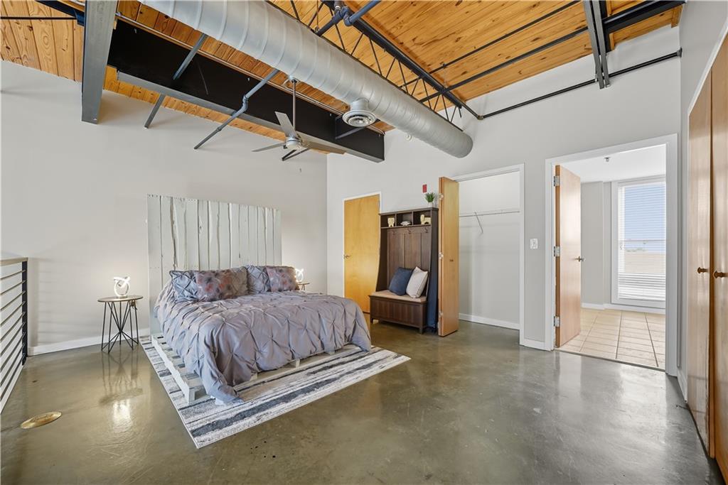 1133 Church Street, Unit 2 Covington, GA 30014 - Photo 18 of 38 a spacious bedroom with a bed and a chandelier