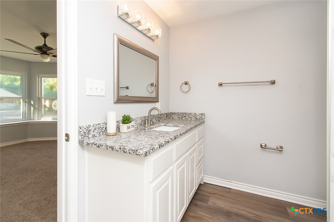 2610 San Jacinto Road Temple, TX 76502 - Photo 14 of 24 a bathroom with a granite countertop sink and a mirror
