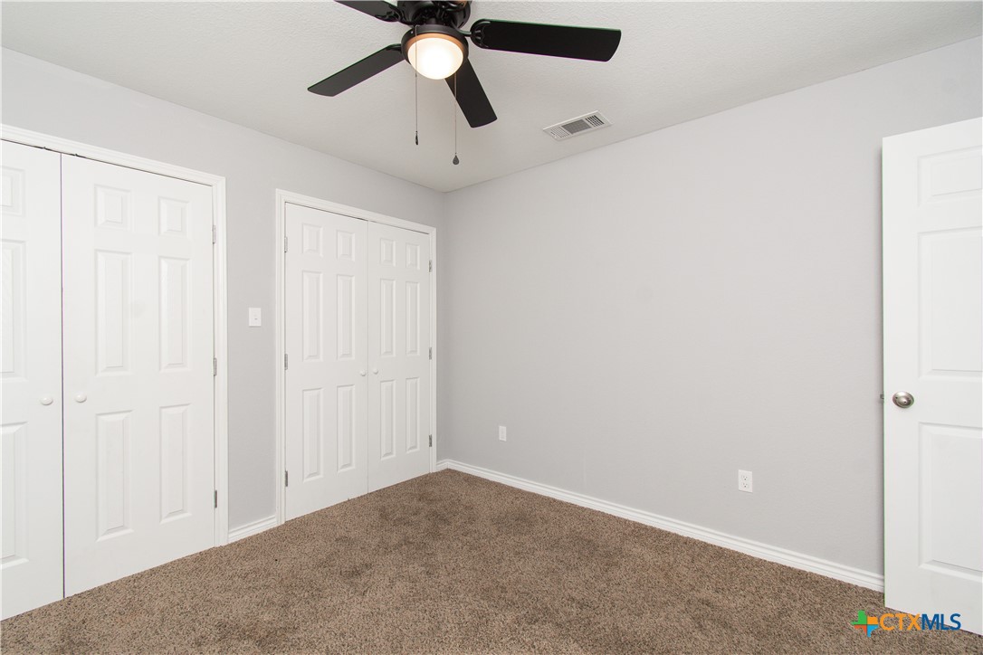 2610 San Jacinto Road Temple, TX 76502 - Photo 16 of 24 an empty room with a ceiling fan and a window