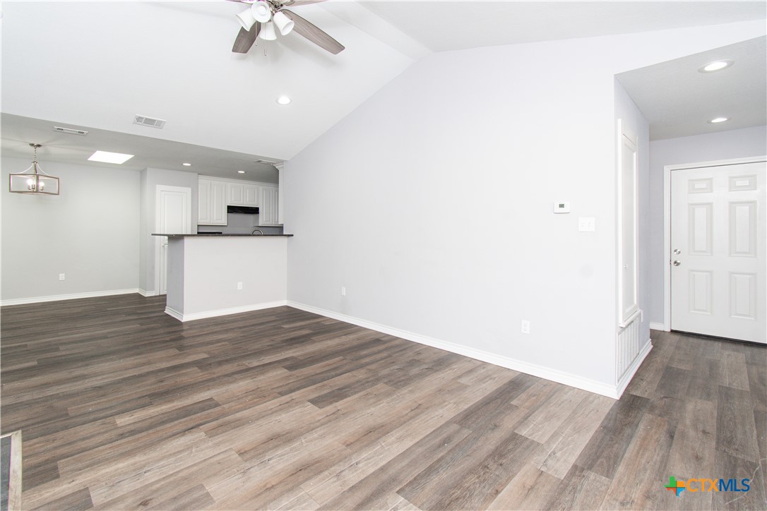 2610 San Jacinto Road Temple, TX 76502 - Photo 4 of 24 an empty room with wooden floor and a ceiling fan