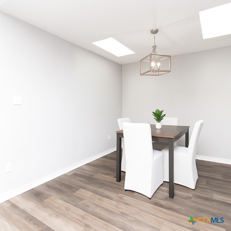 2610 San Jacinto Road Temple, TX 76502 - Photo 7 of 24 a view of a dining room with furniture and wooden floor