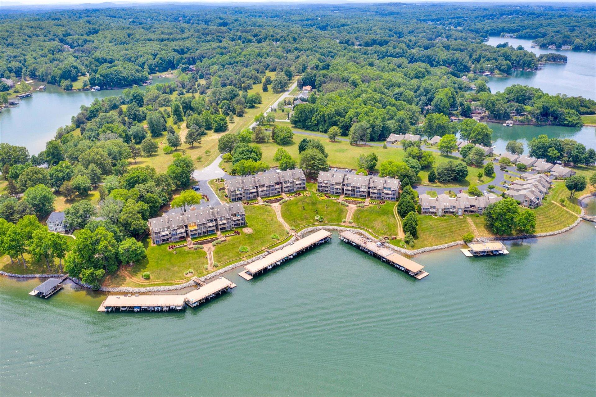 an aerial view of a house with a garden and lake view