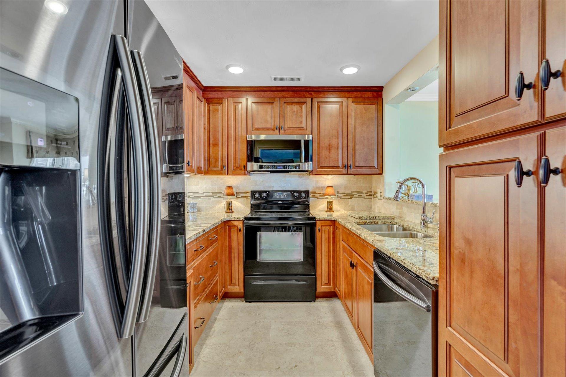 845 Gangplank Road, Unit 207 Moneta, VA 24121 - Photo 11 of 29 a kitchen with stainless steel appliances granite countertop a refrigerator a stove and a sink