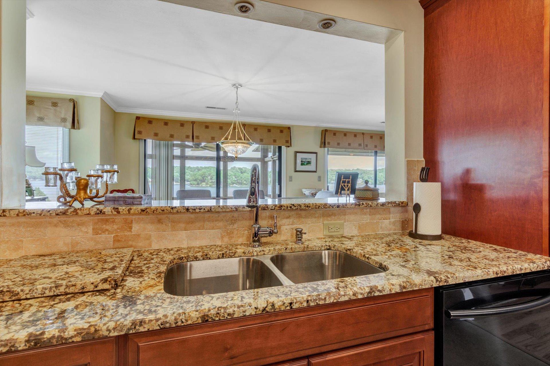845 Gangplank Road, Unit 207 Moneta, VA 24121 - Photo 13 of 29 a view of a kitchen counter top a sink and living room view
