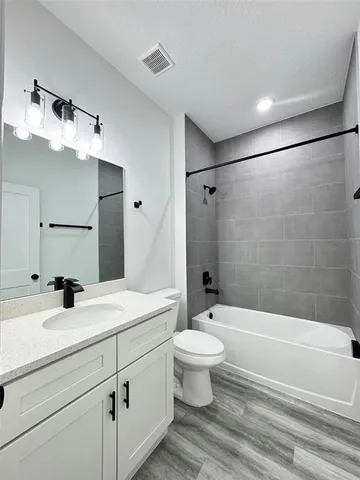 a bathroom with a sink toilet a mirror and shower