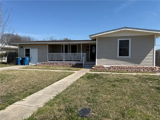 a front view of a house with yard and seating space
