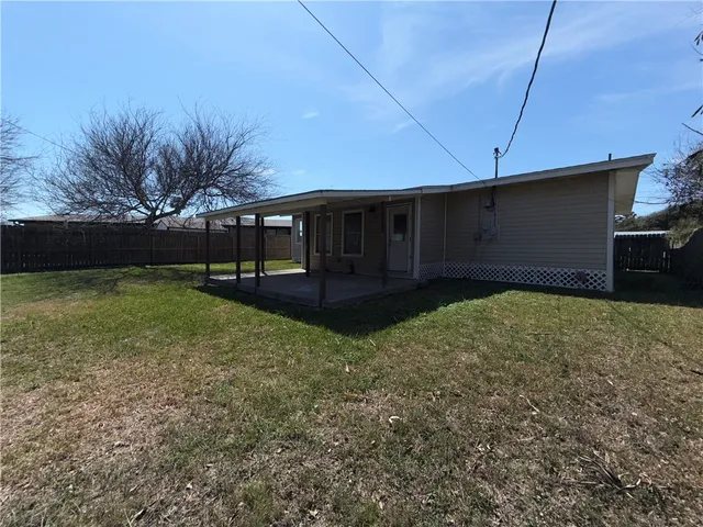 a view of a house with cars park