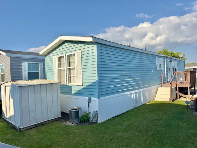 a view of a backyard with potted plants and wooden fence