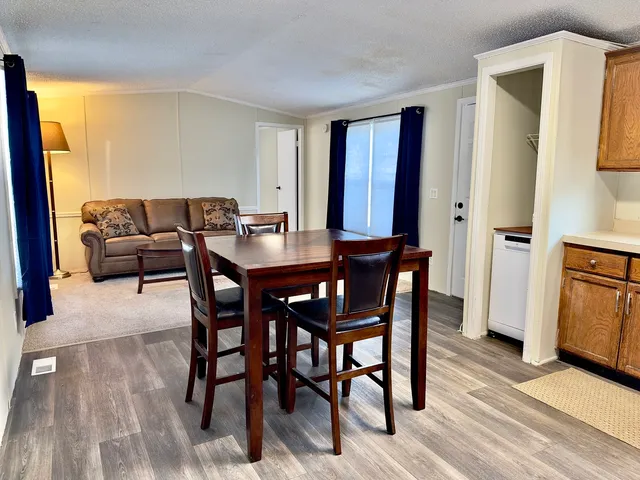 a view of a dining room with furniture window and wooden floor