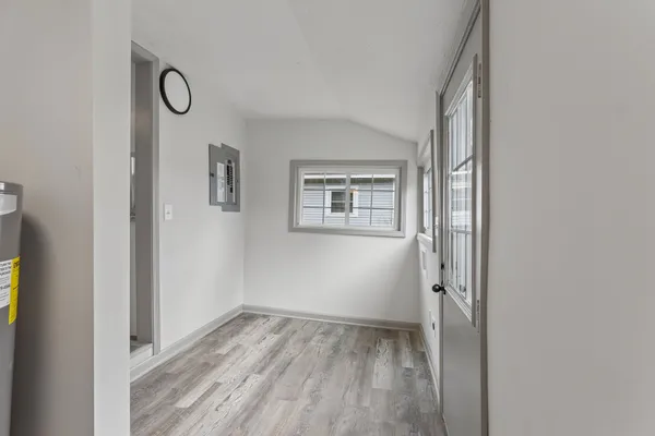 a view of a room that has wooden floor and window