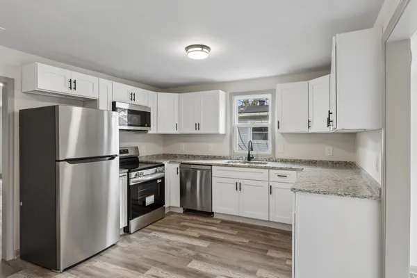 a kitchen with stainless steel appliances granite countertop a stove a refrigerator and a granite counter tops