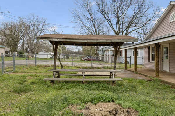 a view of outdoor space with a garden and trees