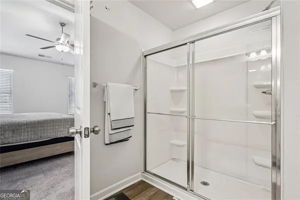 a bathroom with a shower and a glass door