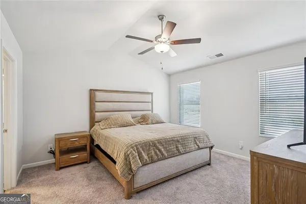 a bedroom with a bed and window