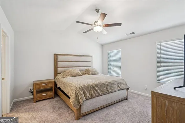 a bedroom with a bed and window