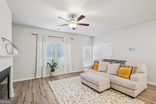a living room with furniture and wooden floor