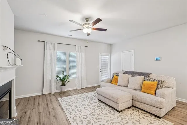 a living room with furniture and wooden floor