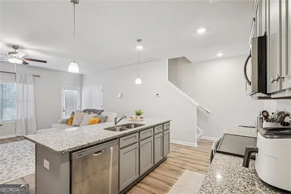 a kitchen with a sink a counter space and appliances