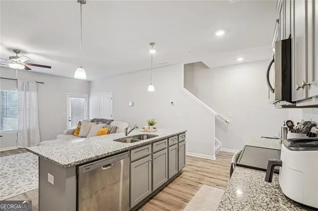 a kitchen with a sink a counter space and appliances