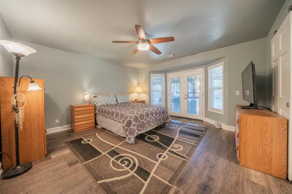 an empty room with mirror and windows